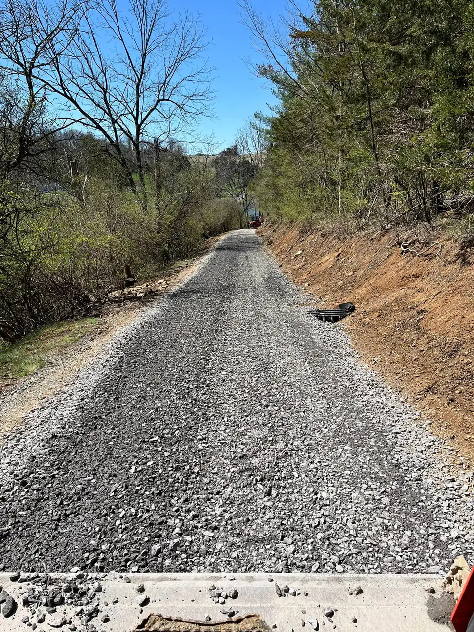 Gravel driveway through wooded hillside